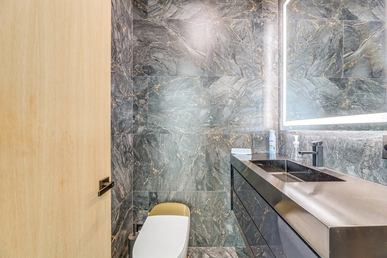 Marble powder room with steel vanity