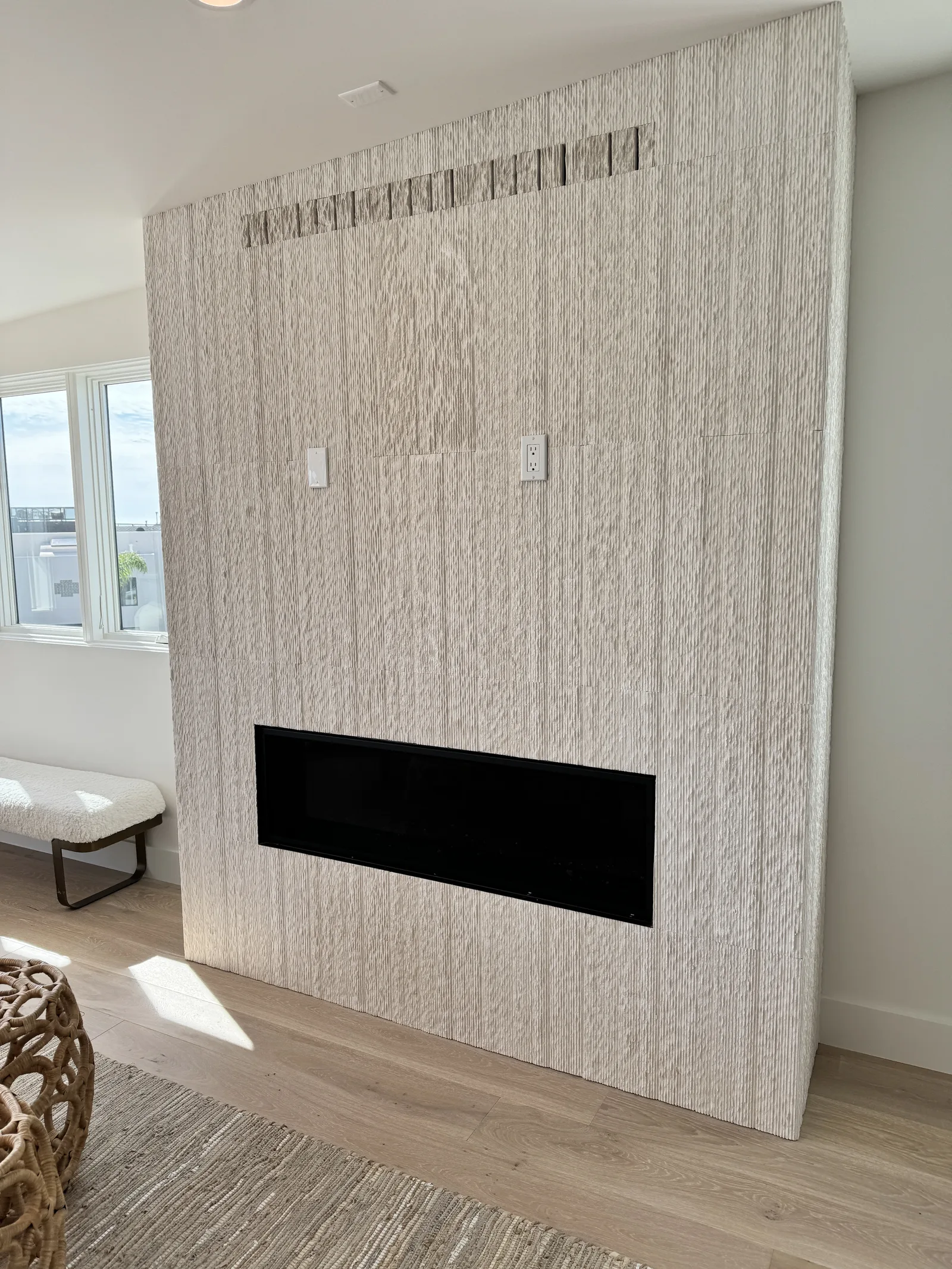 Carved limestone fireplace wall